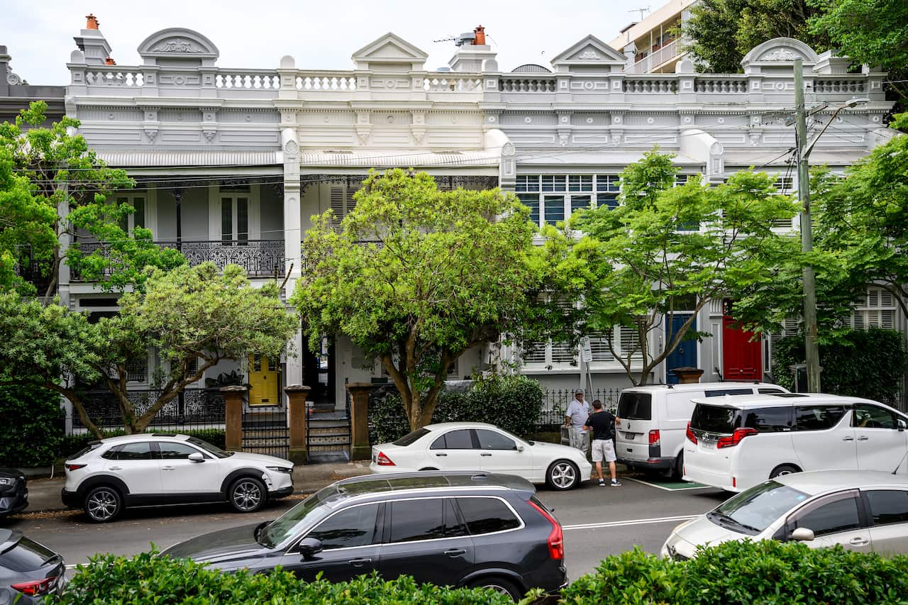 A street view showing several terrace houses. 