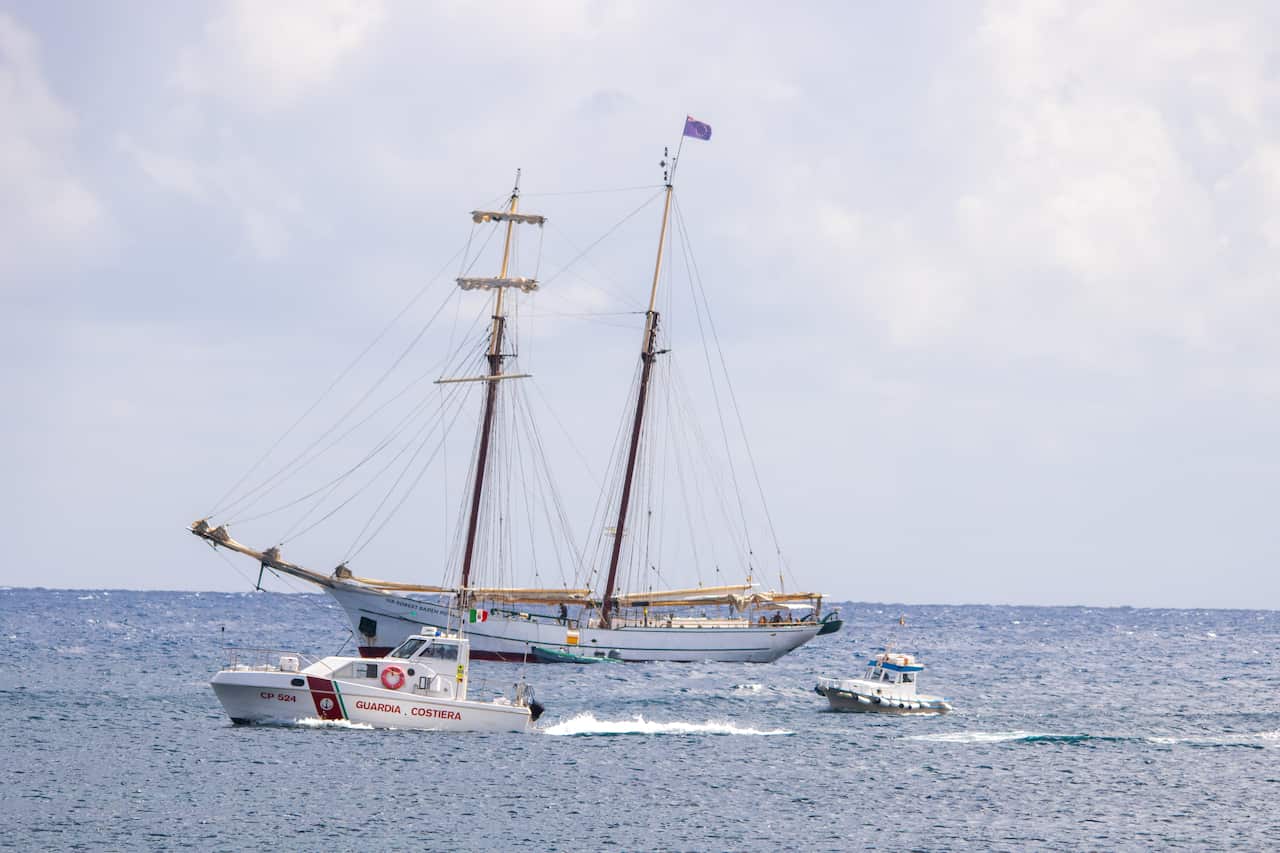 Italian coast guard conducting search operations for Bayesian yacht shipwreck in Sicily.