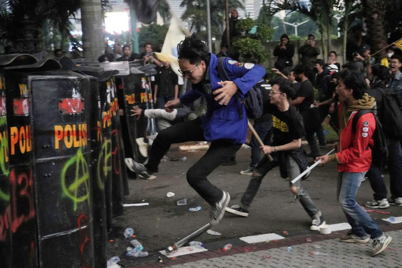 People are destroying public property during a rally.