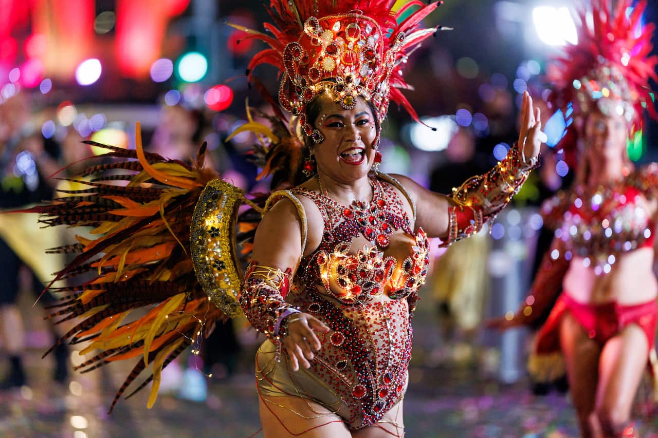 A woman dressed in costume in the Mardi Gras parade.
