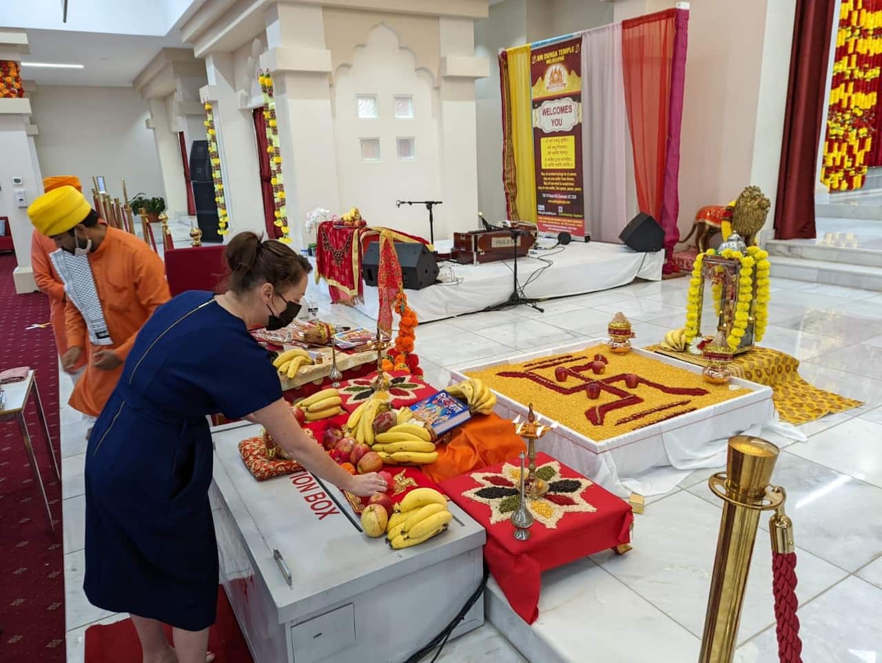 Attendees arrange fruit as part of a ceremony at a Hindu temple in Melbourne. 