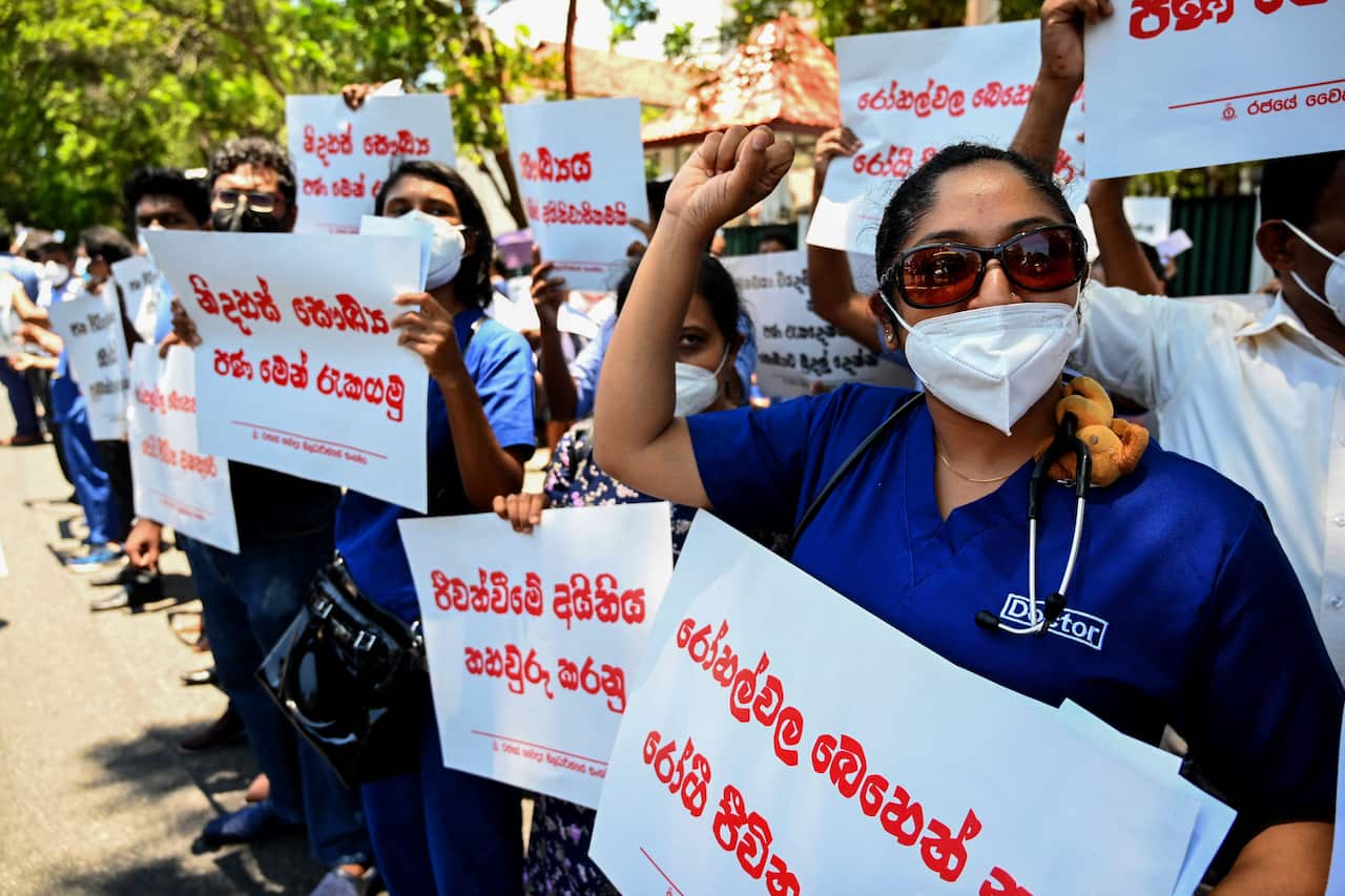 Members of the Government Medical Officers' Association are seen holding placards during a protest in Sri Lanka.