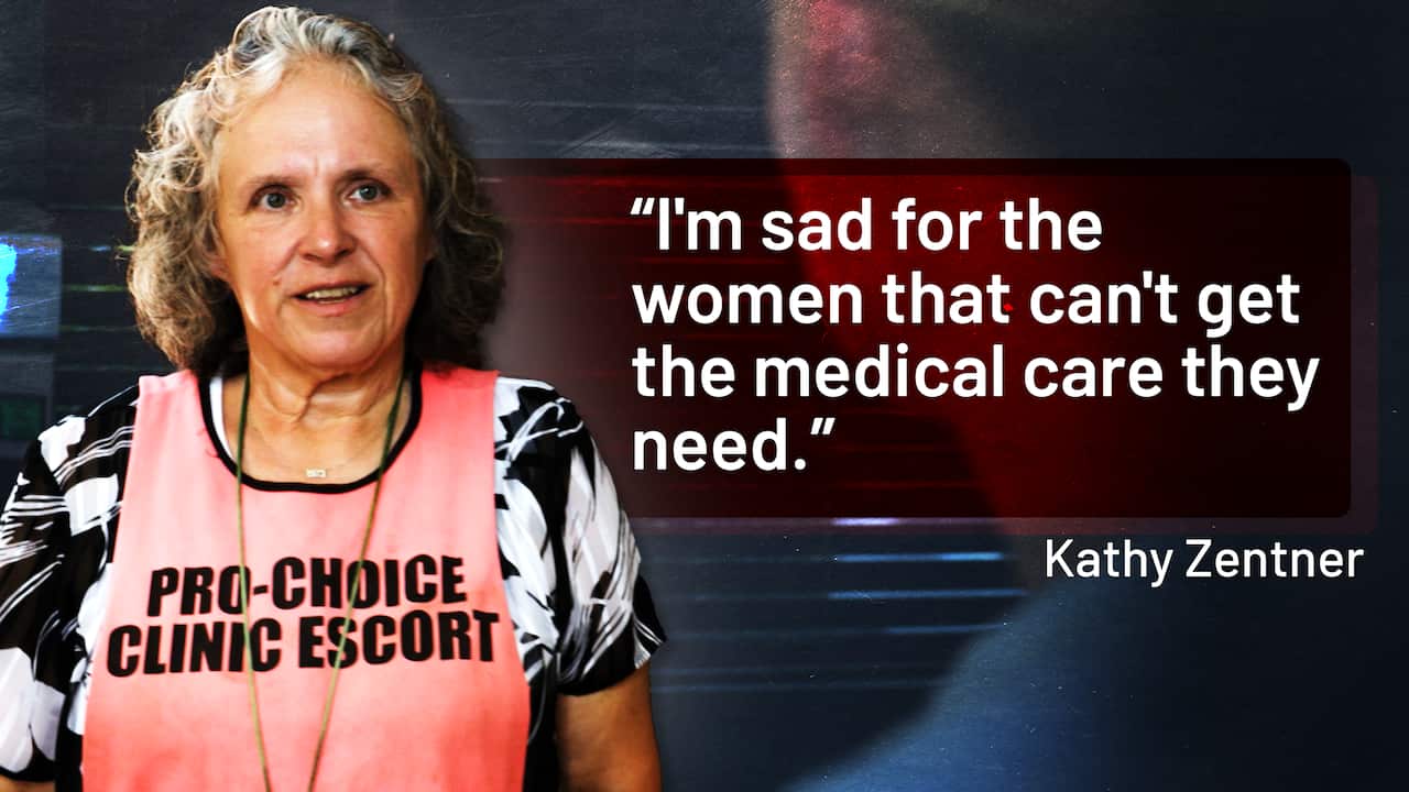 A woman wearing a pink apron.