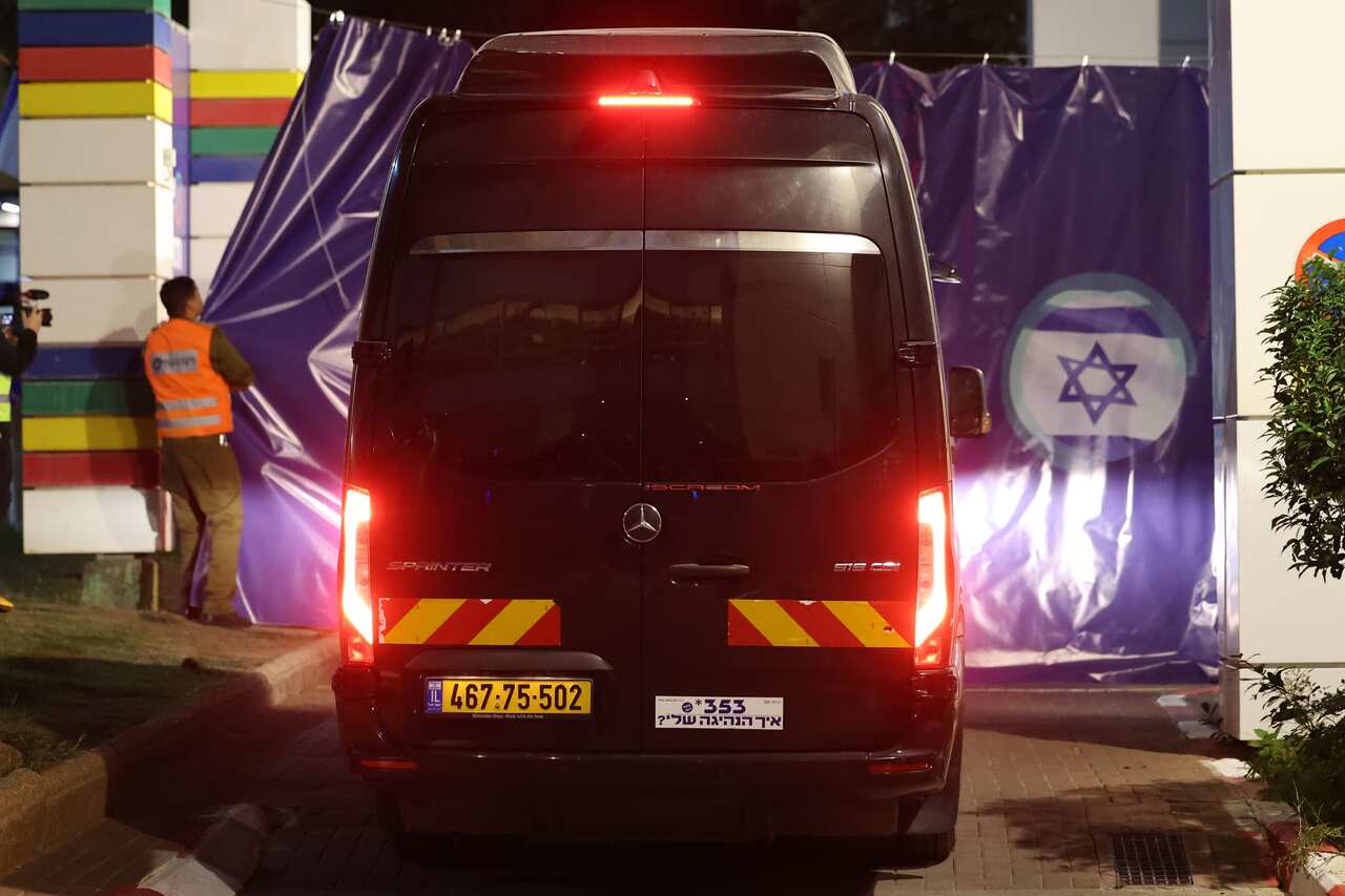 A black van entering a premises.