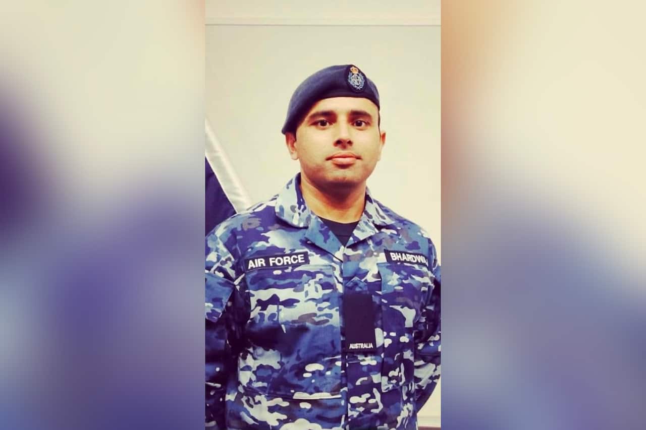 A man of South Asian descent in a blue and grey Australian air force military uniform