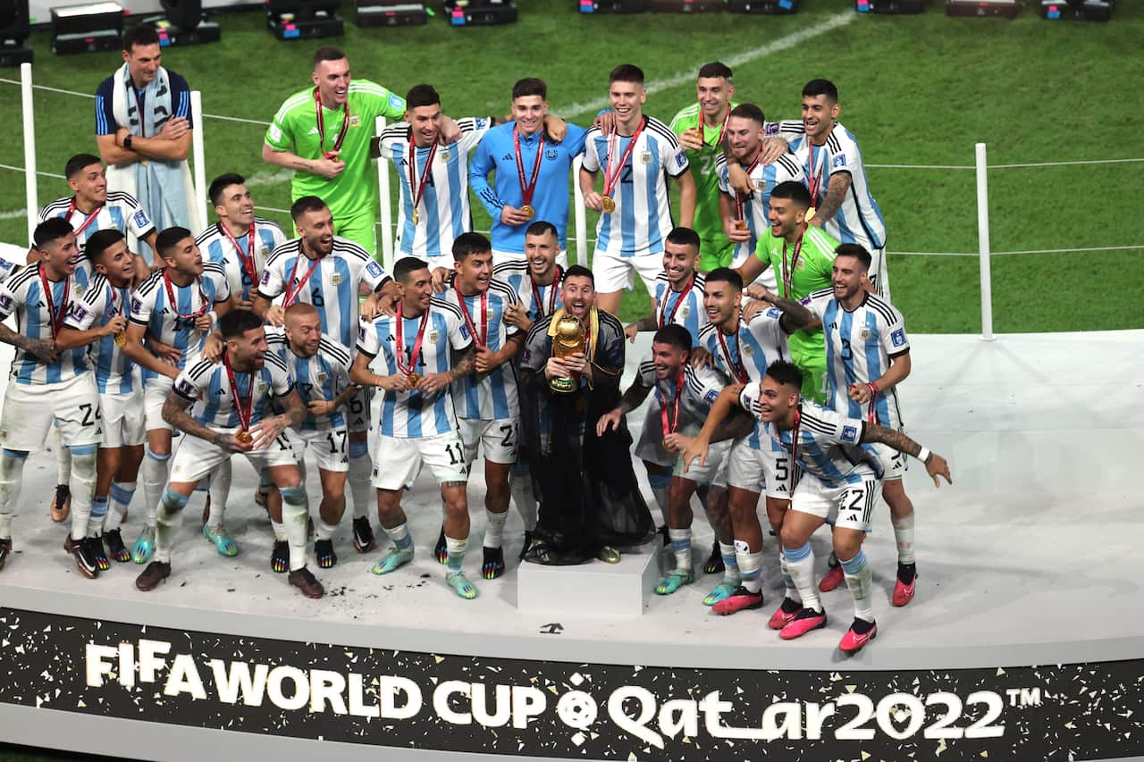 A football cheering while standing on a stage.