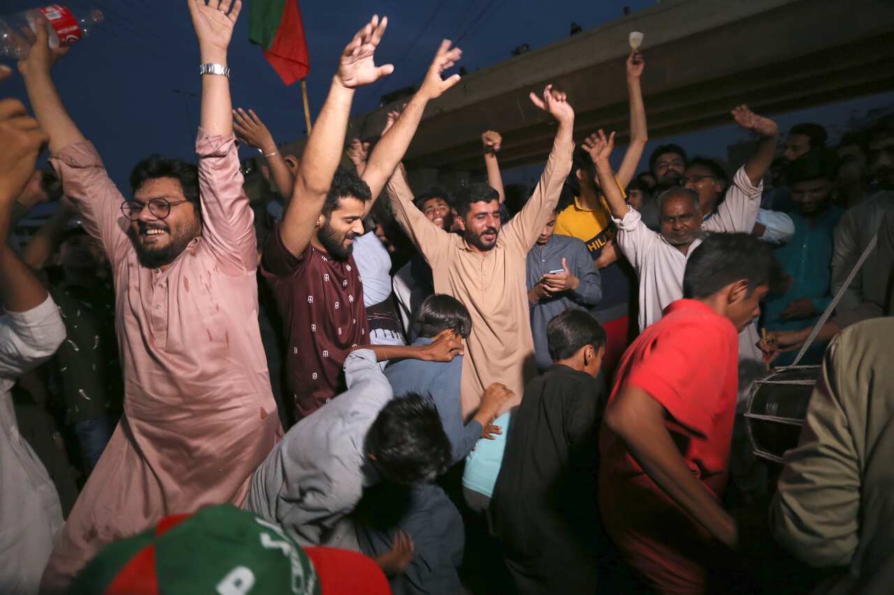 Supporters of Pakistan's former Prime Minister Imran Khan celebrate after the Supreme Court decision to release Khan from arrest.