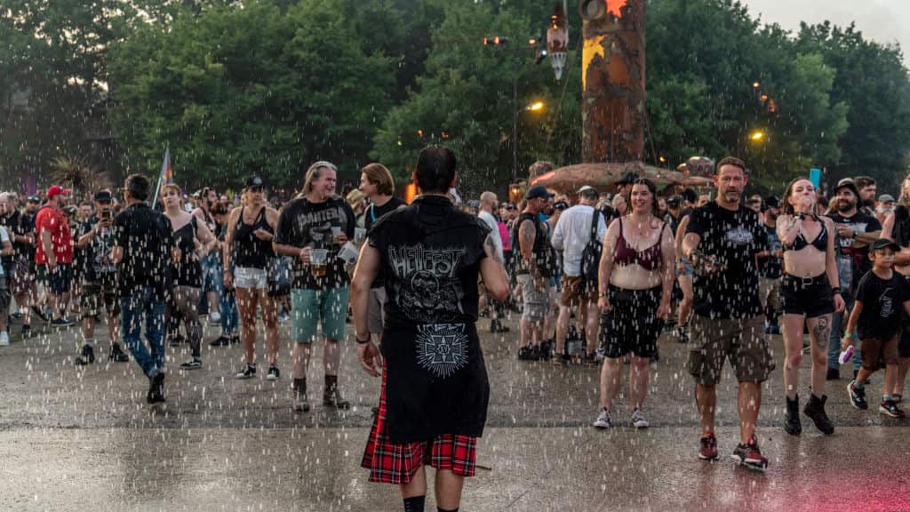 Festival goers cool off under water walls set up by the festival's technical team during the Hellfest festival in Clisson, France.
