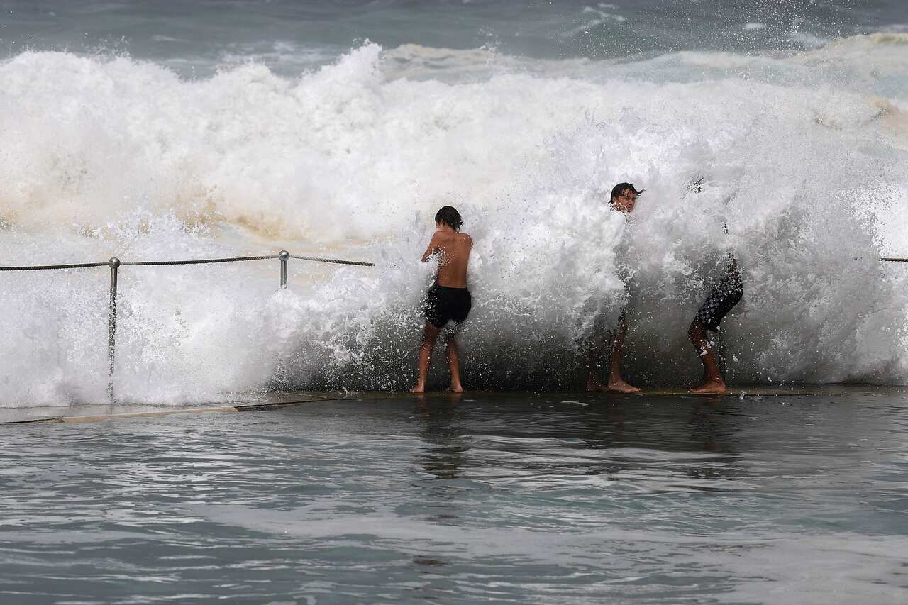 Teenagers battle against storm waves at Bronte Baths Baths, in Sydney on 3 March 2022.  