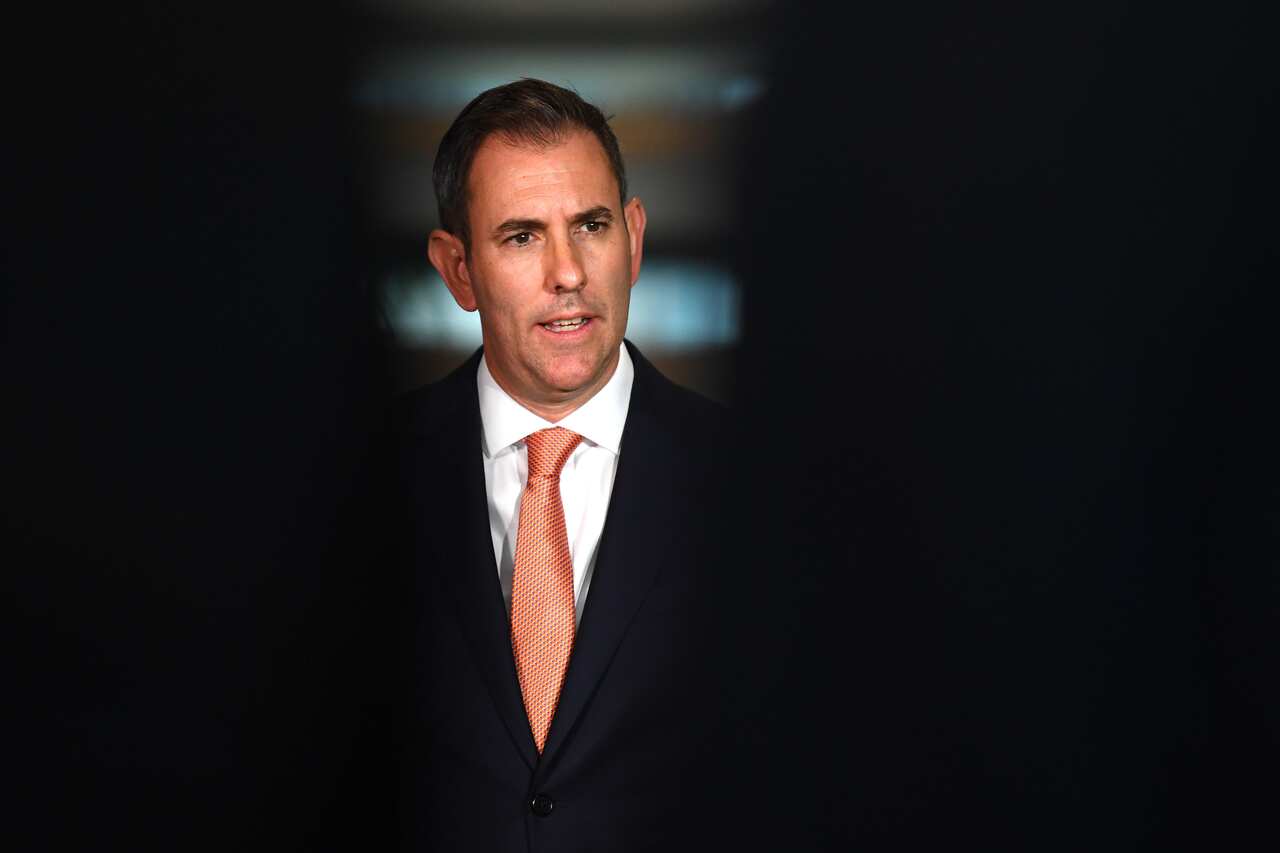 Jim Chalmers standing at a podium